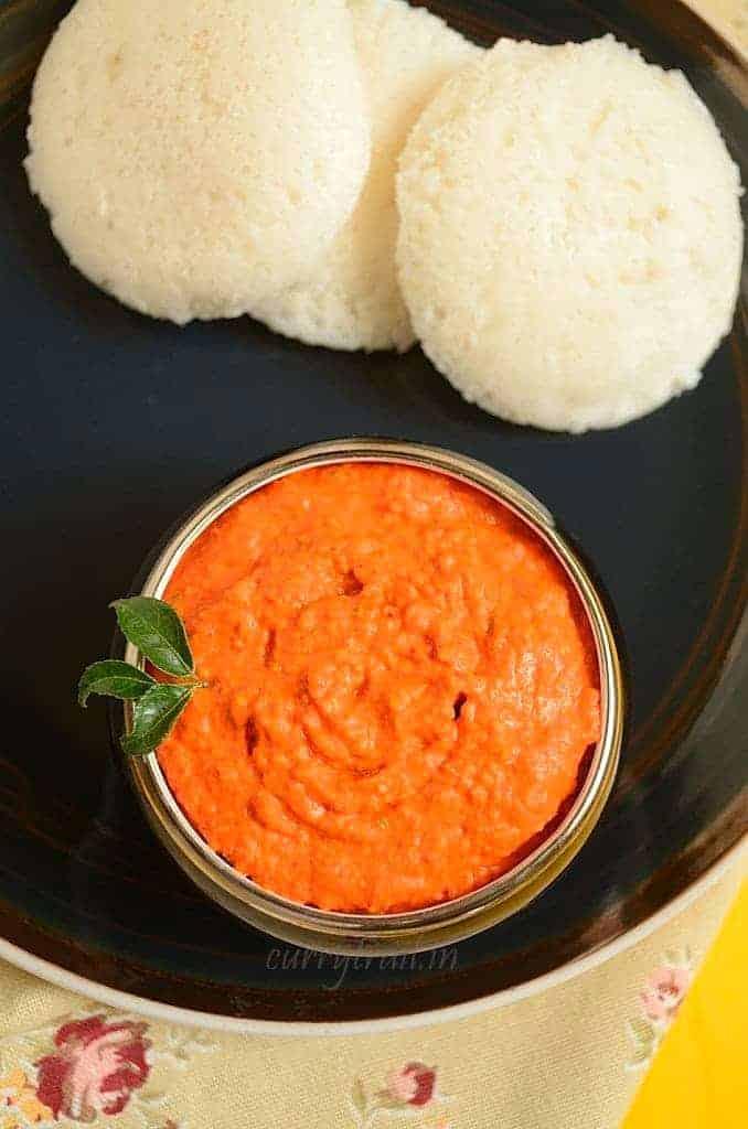 Reddish raw mango chutney served in a bowl with idlis