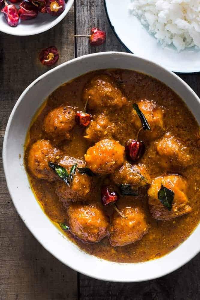 Ripe mango curry in a large white bowl served with rice