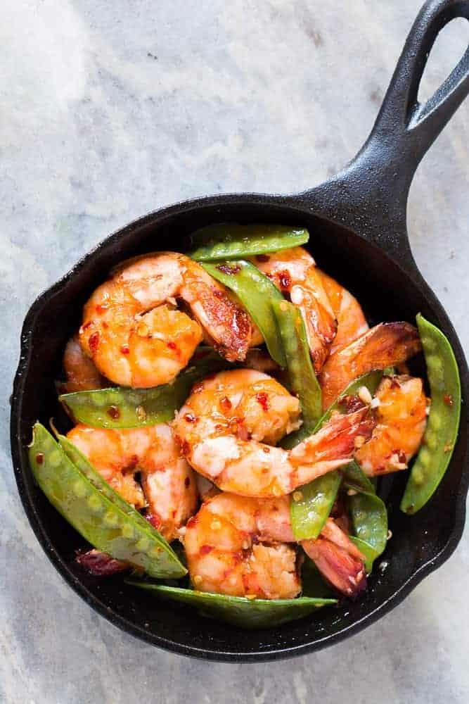 Looking for meals that take under 15 minutes? This is it - 5 ingredient honey garlic chilli jumbo tiger prawns! All the asian flavours you love in this one easy recipe! You can use shrimp, prawns or scampi and add whatever veggie you like - broccoli, bok choy, beans or even spinach! Soy free, gluten free, probably Whole30, Paleo and nut free!