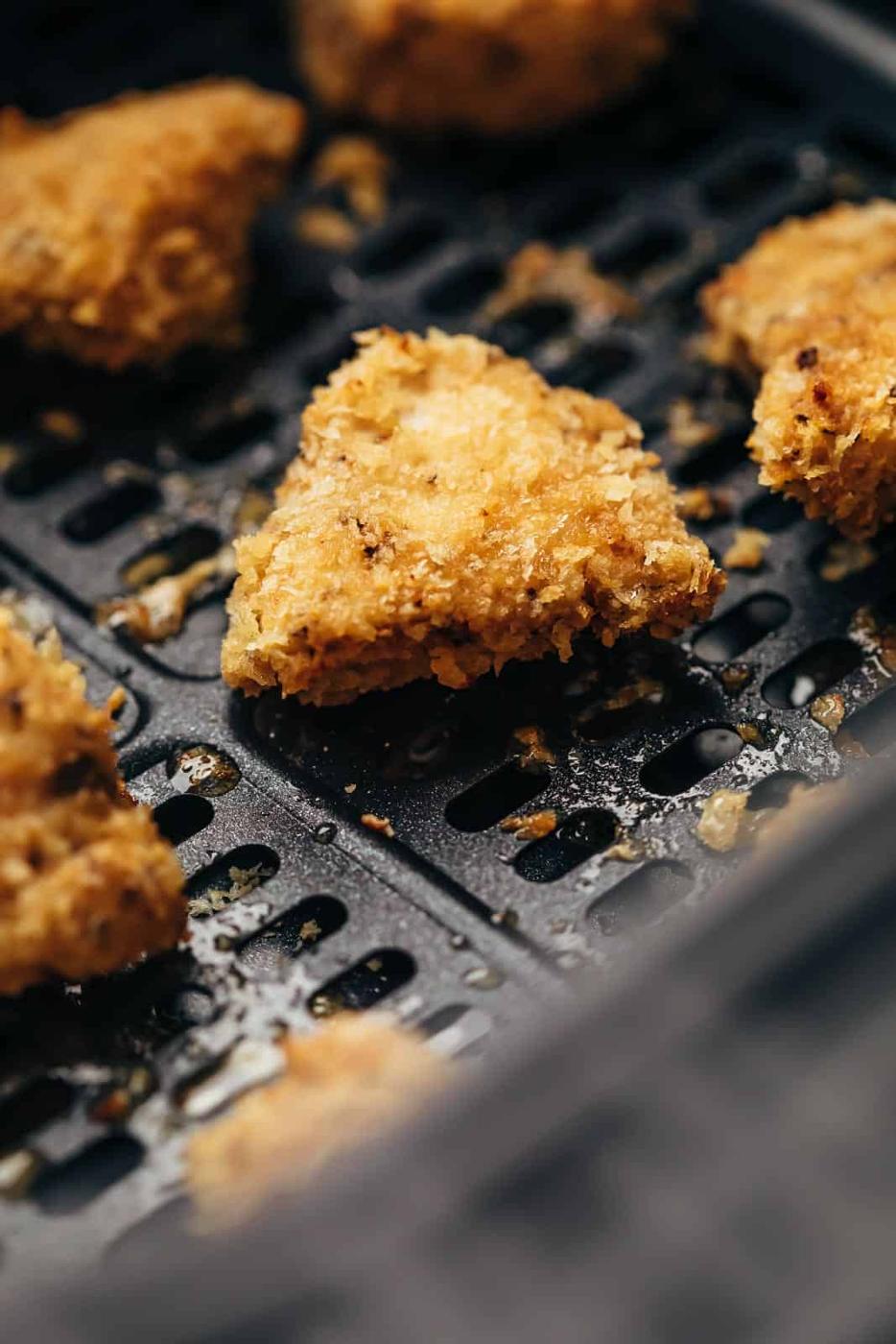 air fryer chicken nuggets cooking in an air fryer