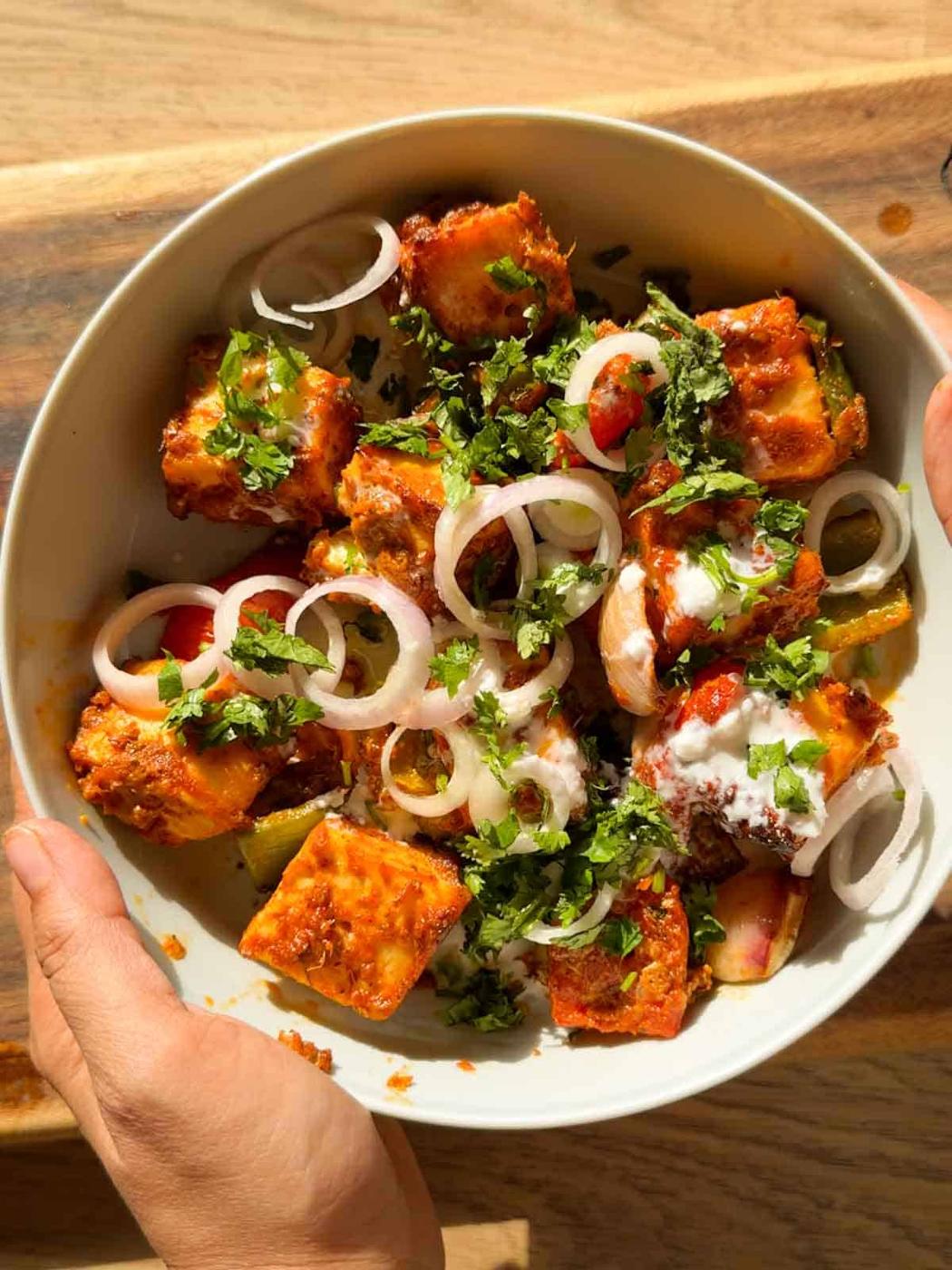 air fryer paneer tikka served in a whie bowl with accompaniments