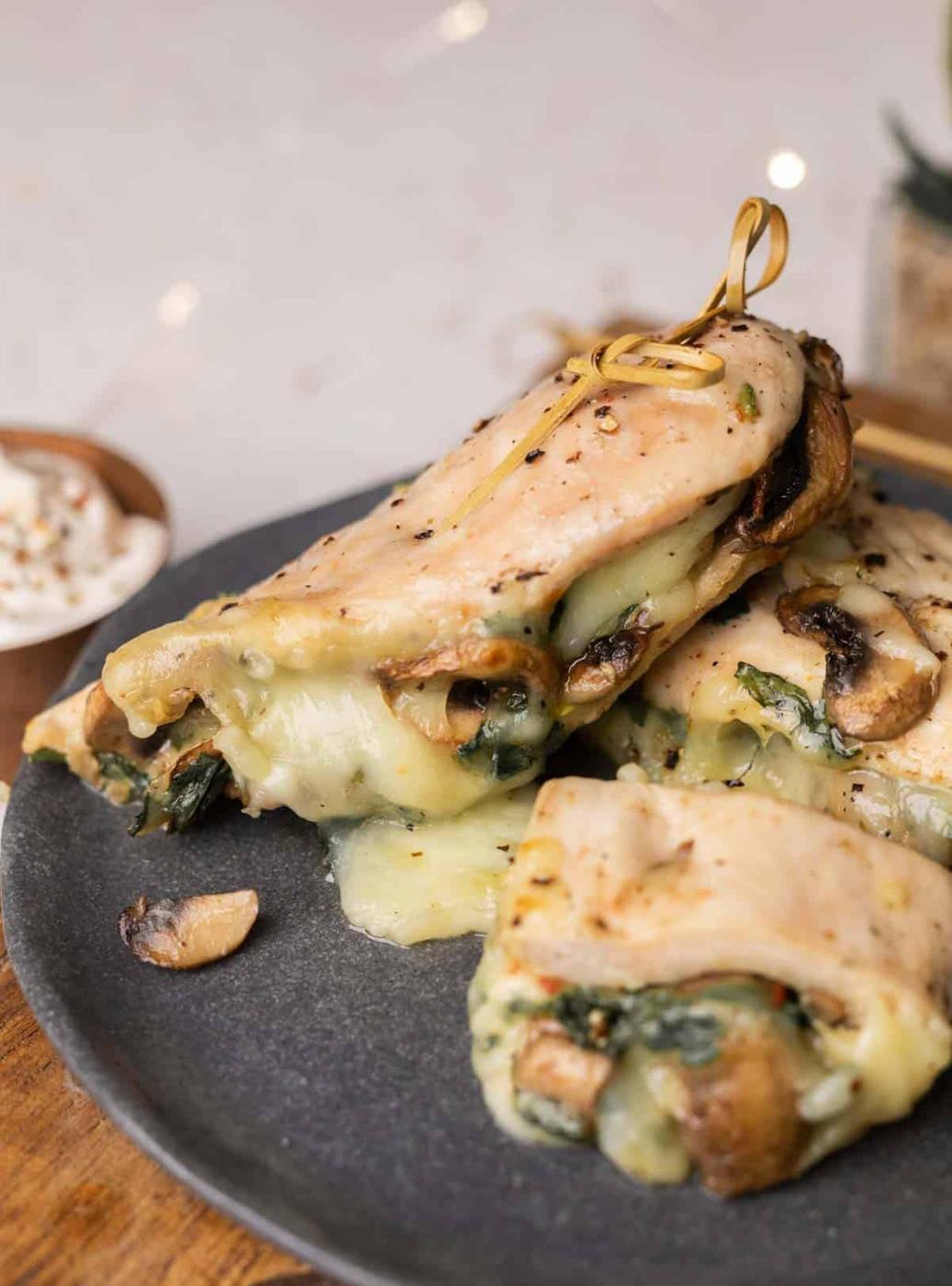 stuffed chicken breast served on a dark grey plate