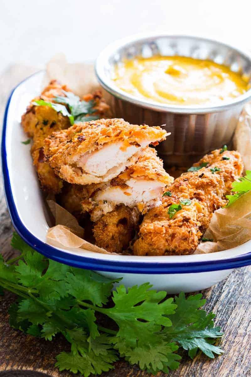 Easy recipe for super crunchy baked coconut crusted chicken tenders which are going to be a favourite at every party with kids and adults alike! Gluten free too.