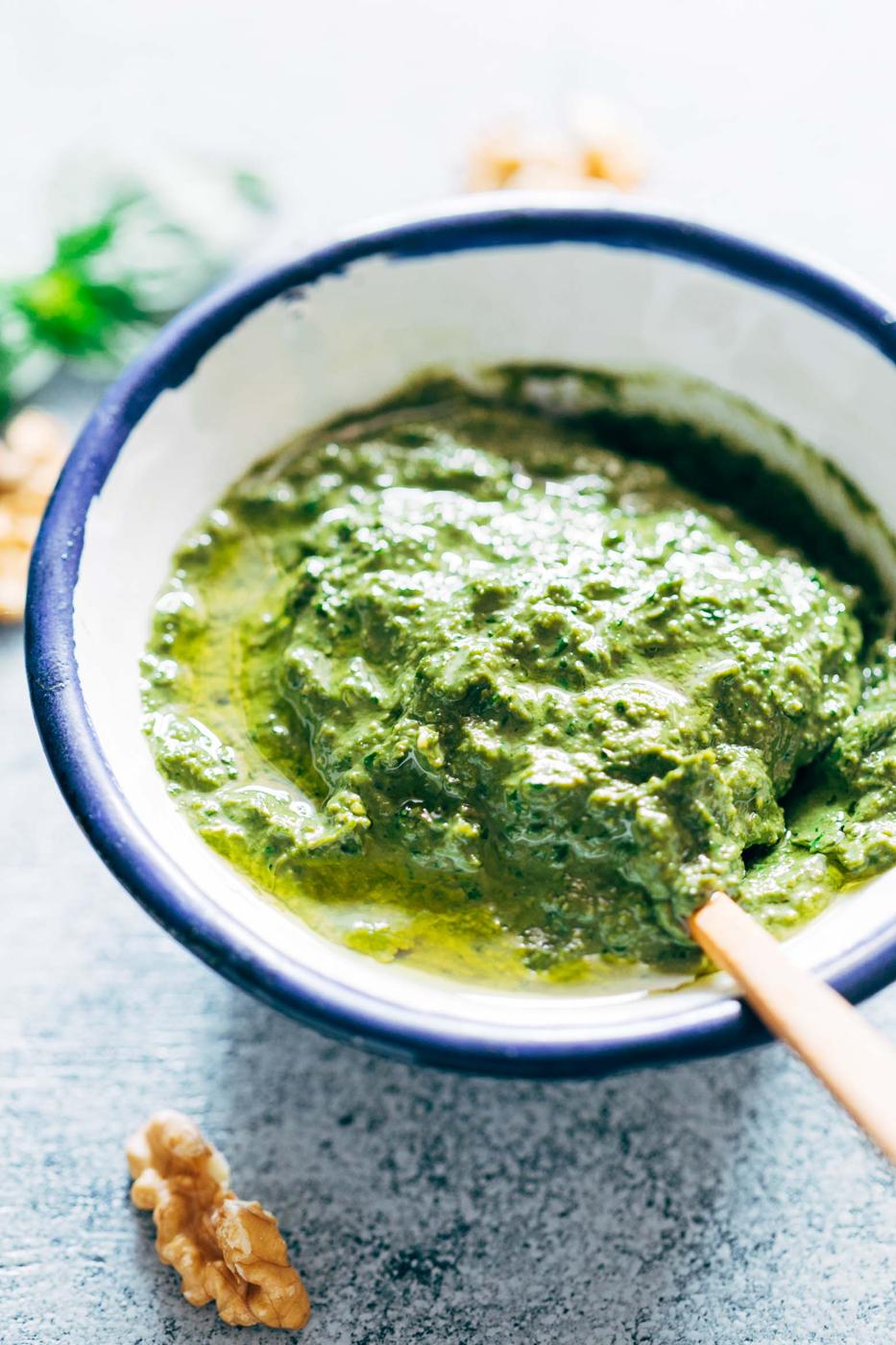 Basil Walnut Pesto is a super easy, homemade vegan pesto recipe that is perfect with pasta dishes, salads, on chicken and salmon as a sauce or even as a dip! The walnuts give it a creamy base which helps avoid the parmesan altogether, and are a great substitute to pine nuts.