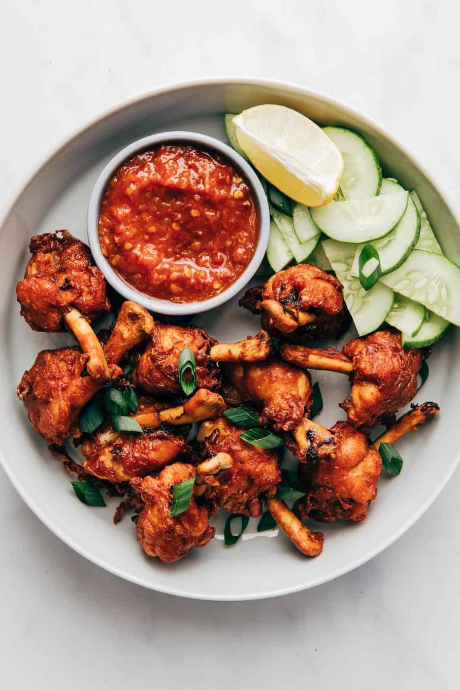 Fried chicken lollipops ready to be served with schezwan sauce