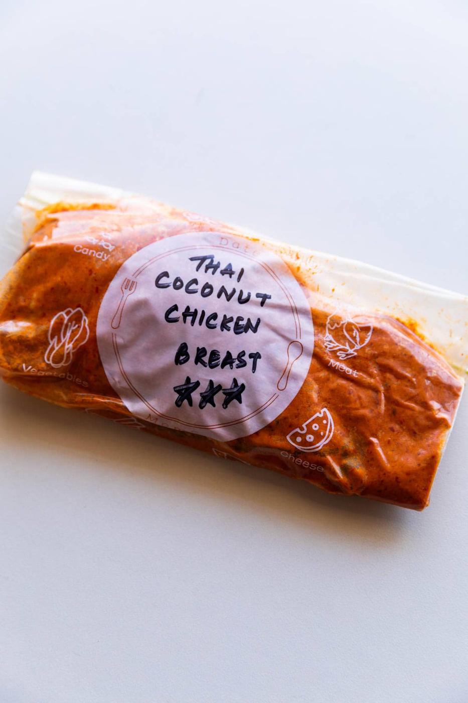 chicken breast marinated in thai coconut marinade and stored in a labelled zip lock bag