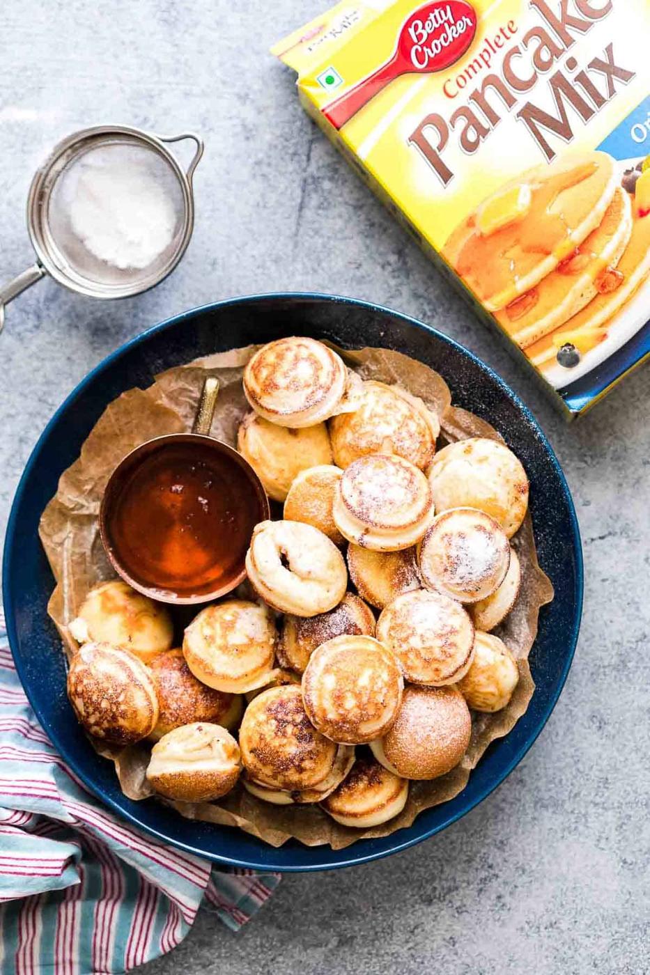 Chocolate Stuffed Mini Pancake Bites served with maple syrup on the side.
