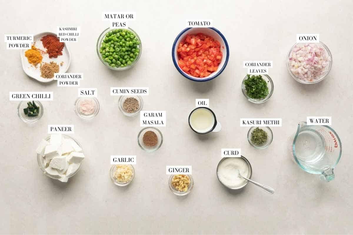 Picture of all the ingredients for matar paneer with text to identify them