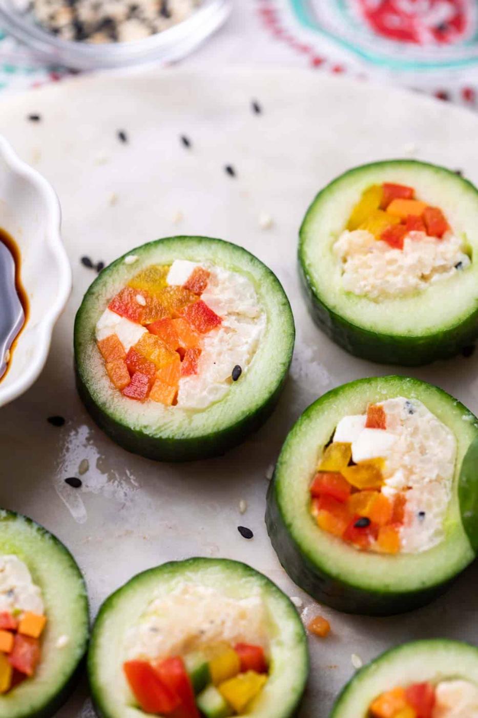 close up of cucumber sushi served with soy sauce