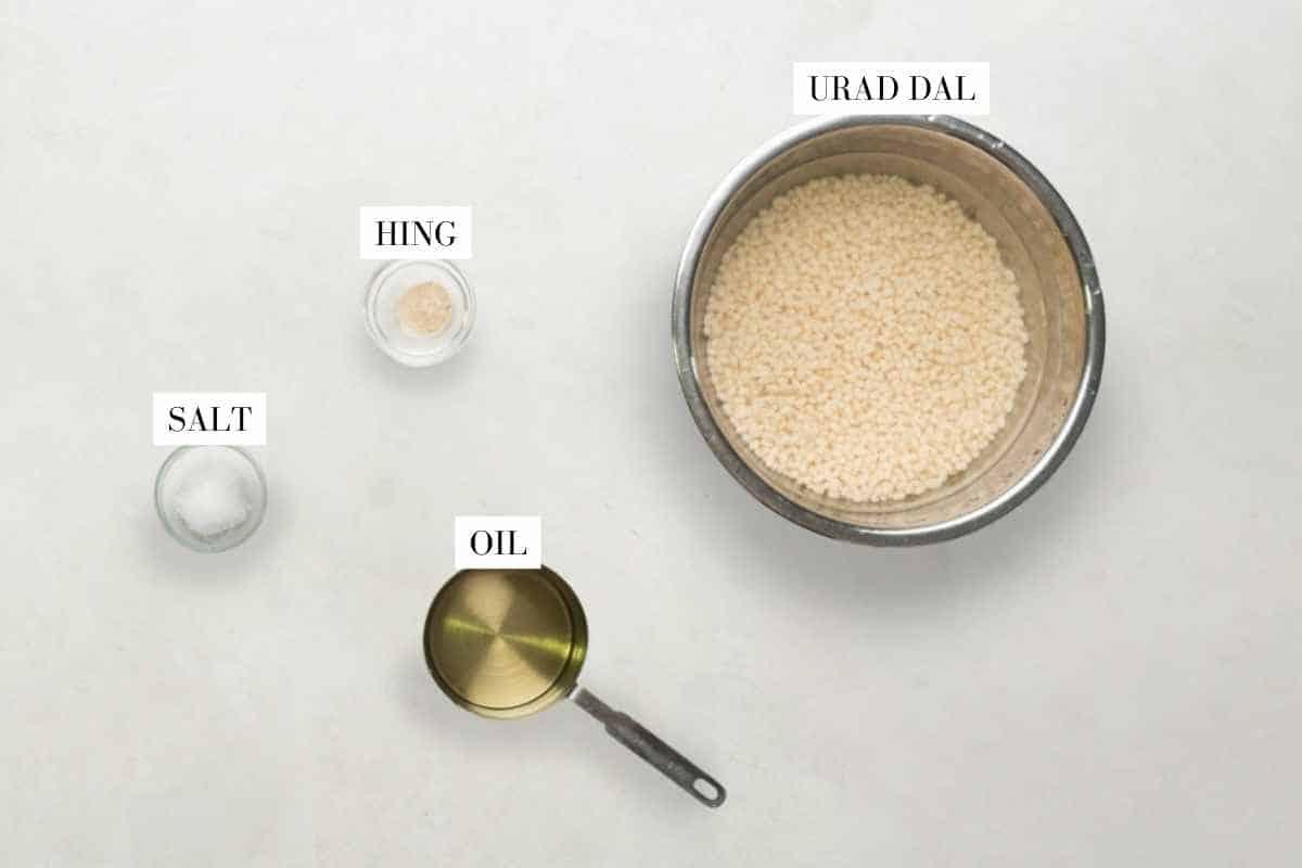 Picture of all the ingredients required for Dahi Vada with text to identify them