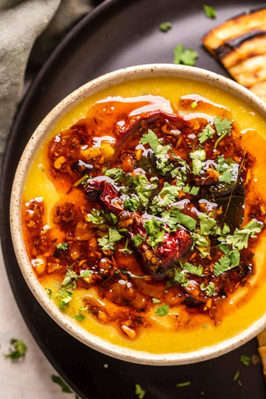 Closeup of dhaba dal tadka served in a ceramic bowl