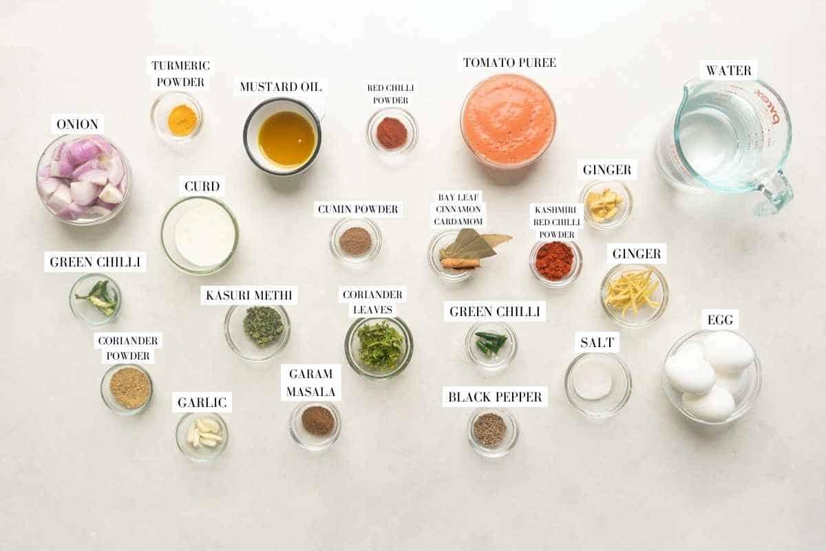 Picture of all the ingredients required for the Dhaba Egg Curry with text to identify them