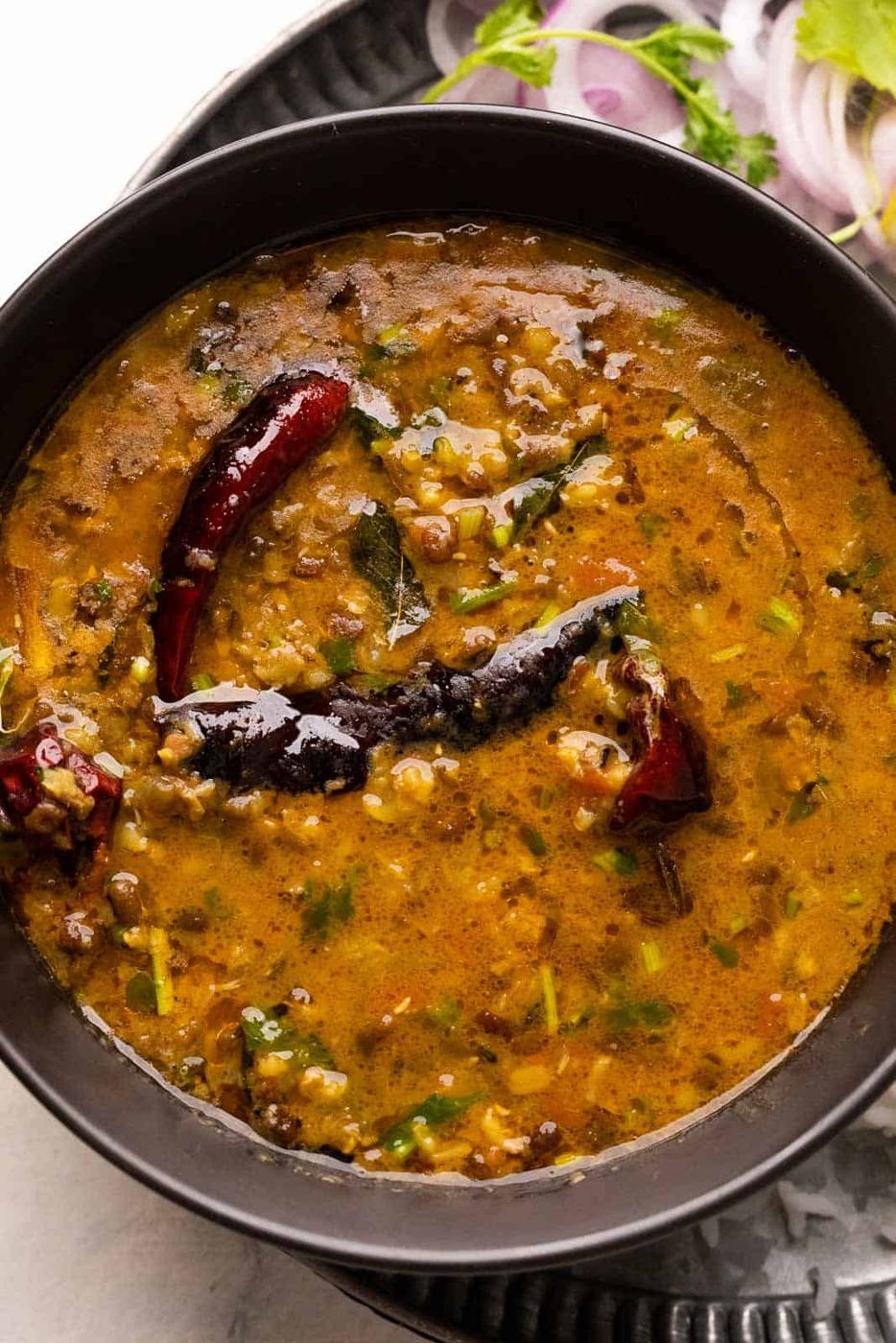 Closeup of a bowl of dhaba style moong dal with tadka on top