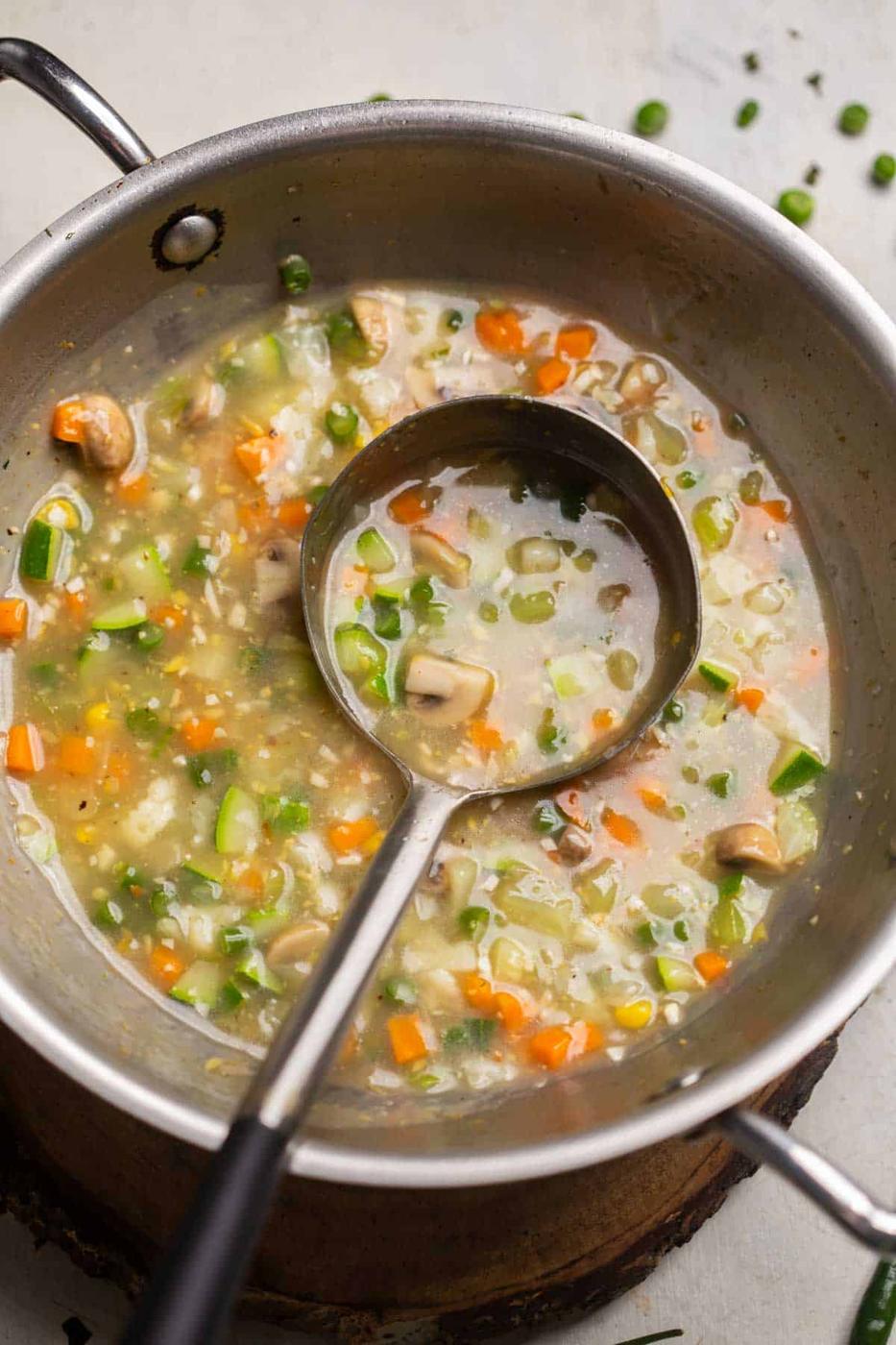 Freshly cooked Eight treasure soup still in the kadai with a ladle