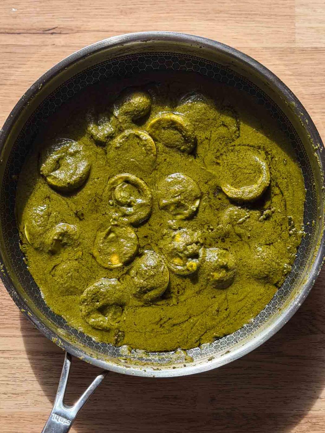 green egg curry in it's cooking vessel ready for serving