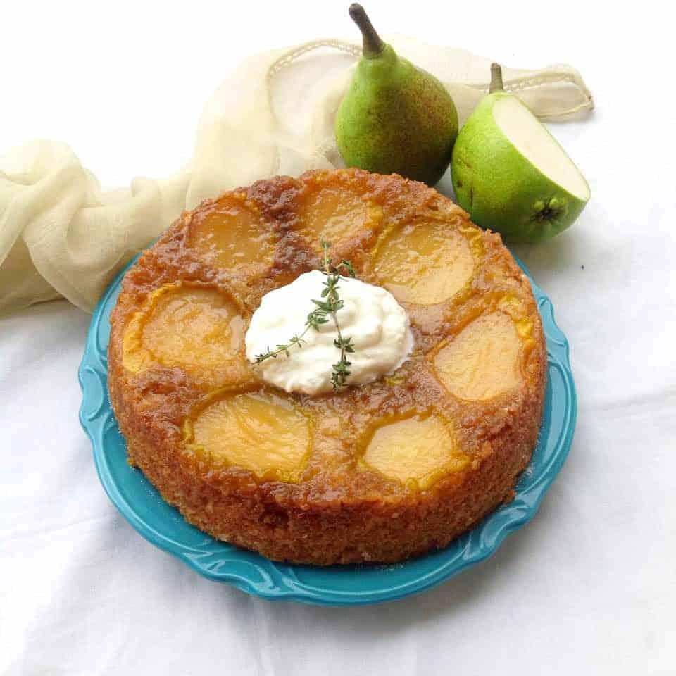 upside down pear cake served on a blue plate