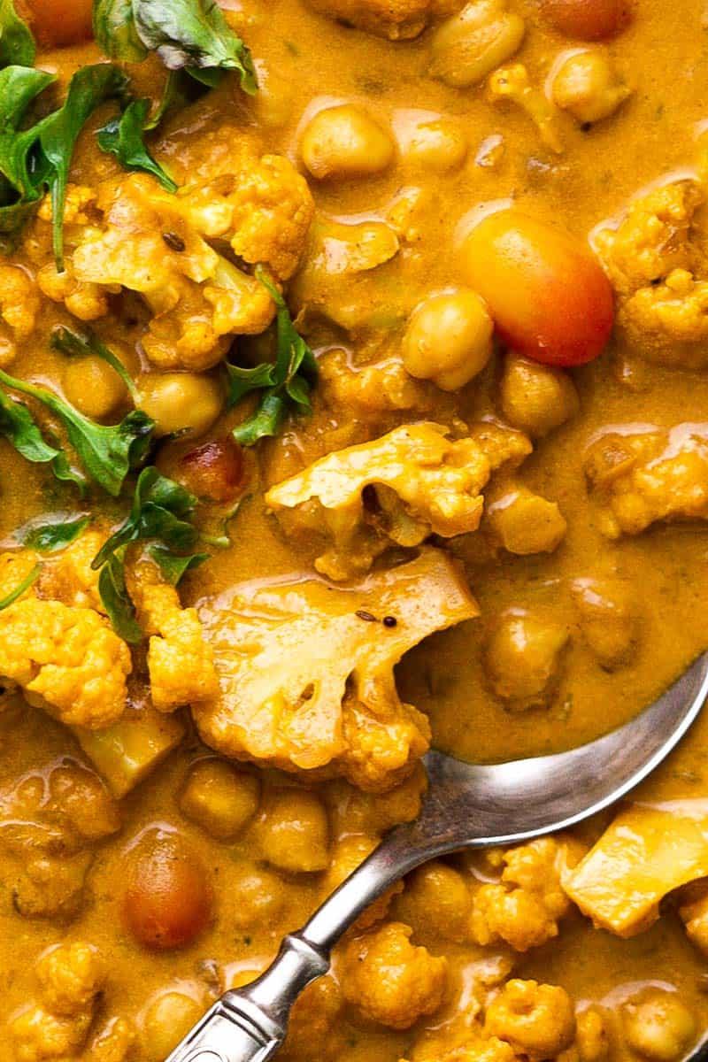 Closeup of Cauliflower Chickpea Coconut Curry with a spoon