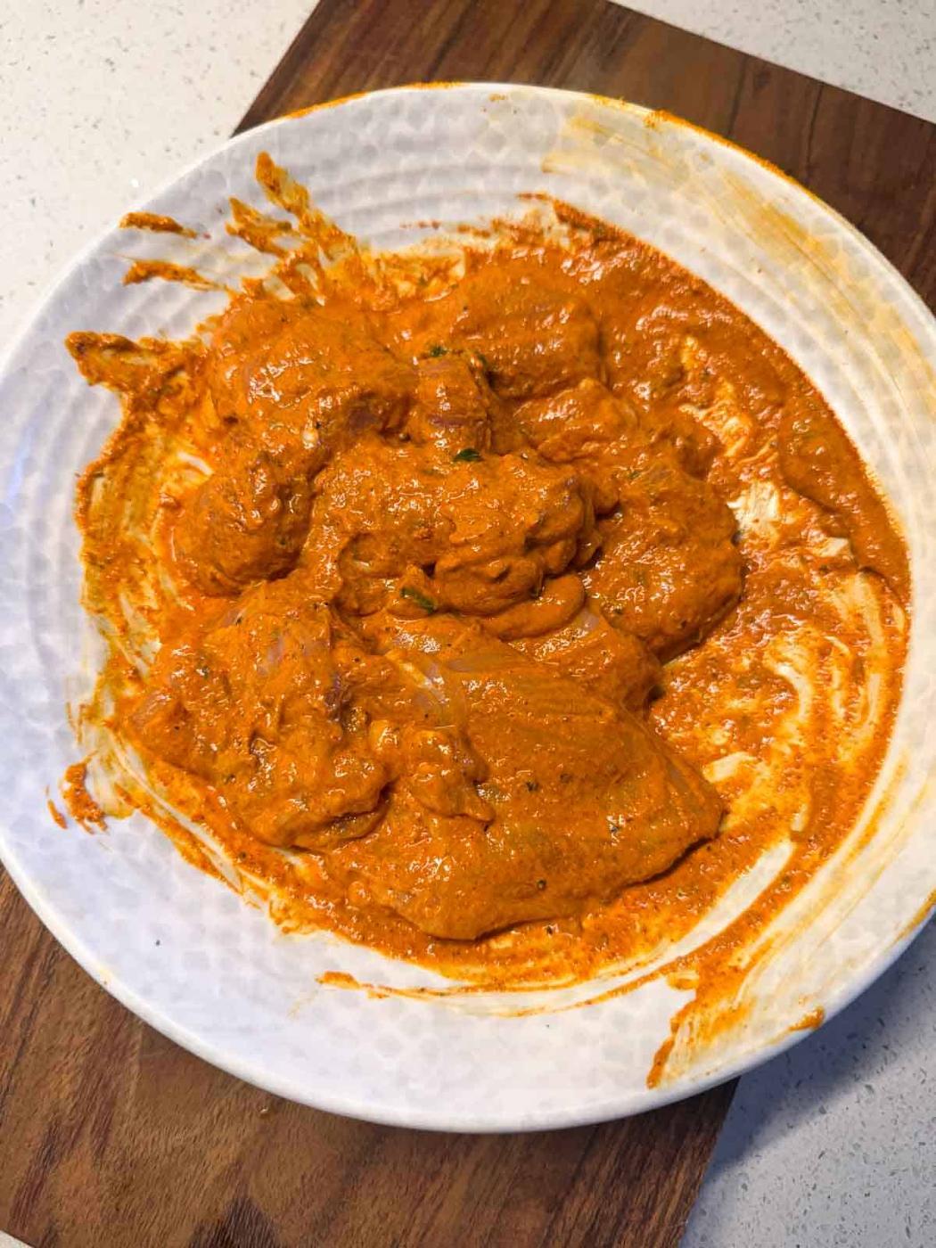 bone-in chicken leg pieces pieces marinated in a yogurt-spice marinade of iffa chicken