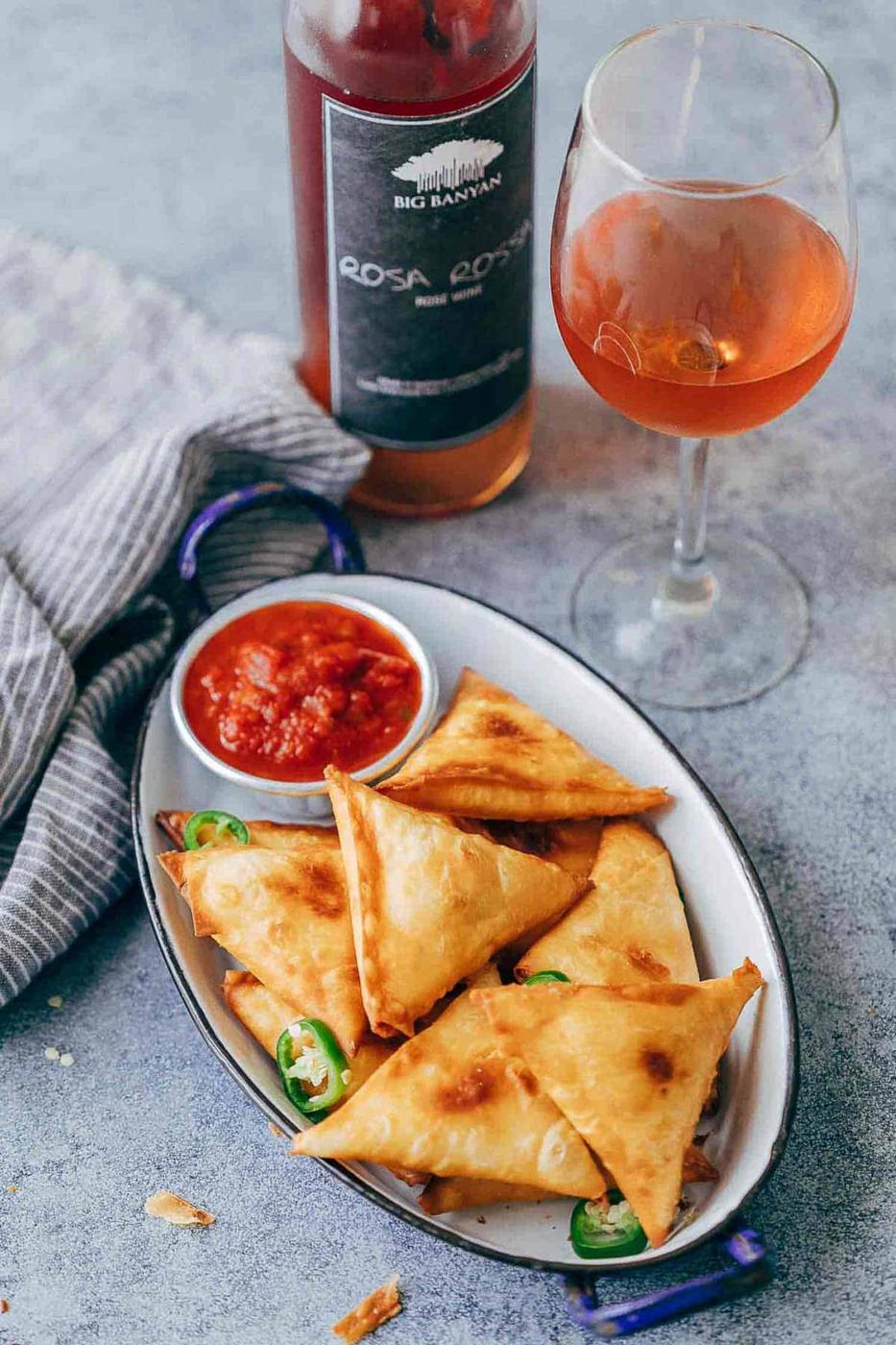 Super cheesy jalapeno three cheese samosa are sure to become a favourite because who can resist gooey stringy cheese stuffed in crispy samosa wrappers! These vegetarian samosas have a filling of mozzarella, cream cheese, smoked cheddar and jalapenos and folding them is really easy too.