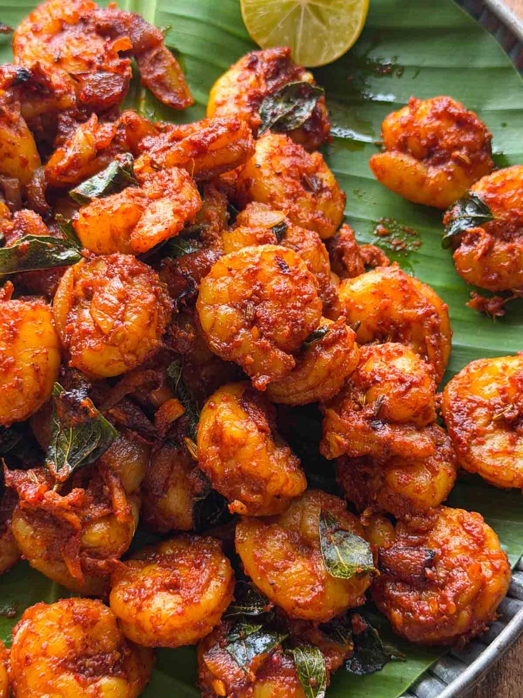 kerala prawn roast served over a banana leaf