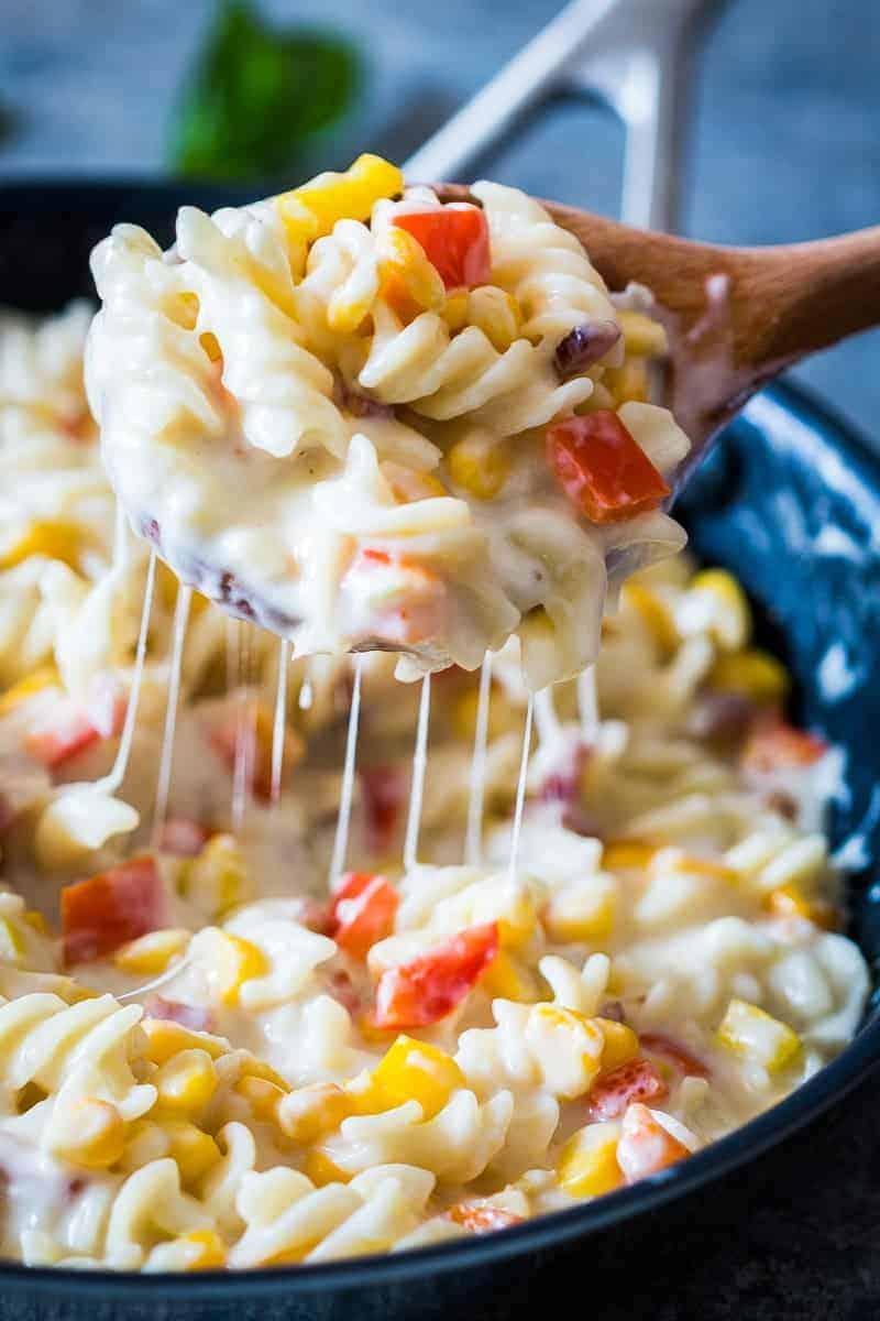 A lighter, creamier corn pepper fusilli alfredo so that you can have your fill without the guilt! There are some real substitutions with whole wheat flour, skim milk and half the cheese making the sauce.