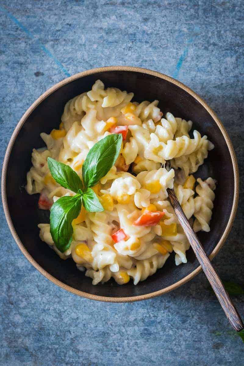 A lighter, creamier corn pepper fusilli alfredo so that you can have your fill without the guilt! There are some real substitutions with whole wheat flour, skim milk and half the cheese making the sauce.