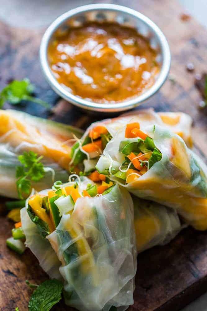 These mango bell pepper rice paper rolls are the perfect summer food! They are stuffed with lots of amazing veggies and come with an insanely delicious mango cilantro dipping sauce! These are naturally gluten free, vegan and low carb!