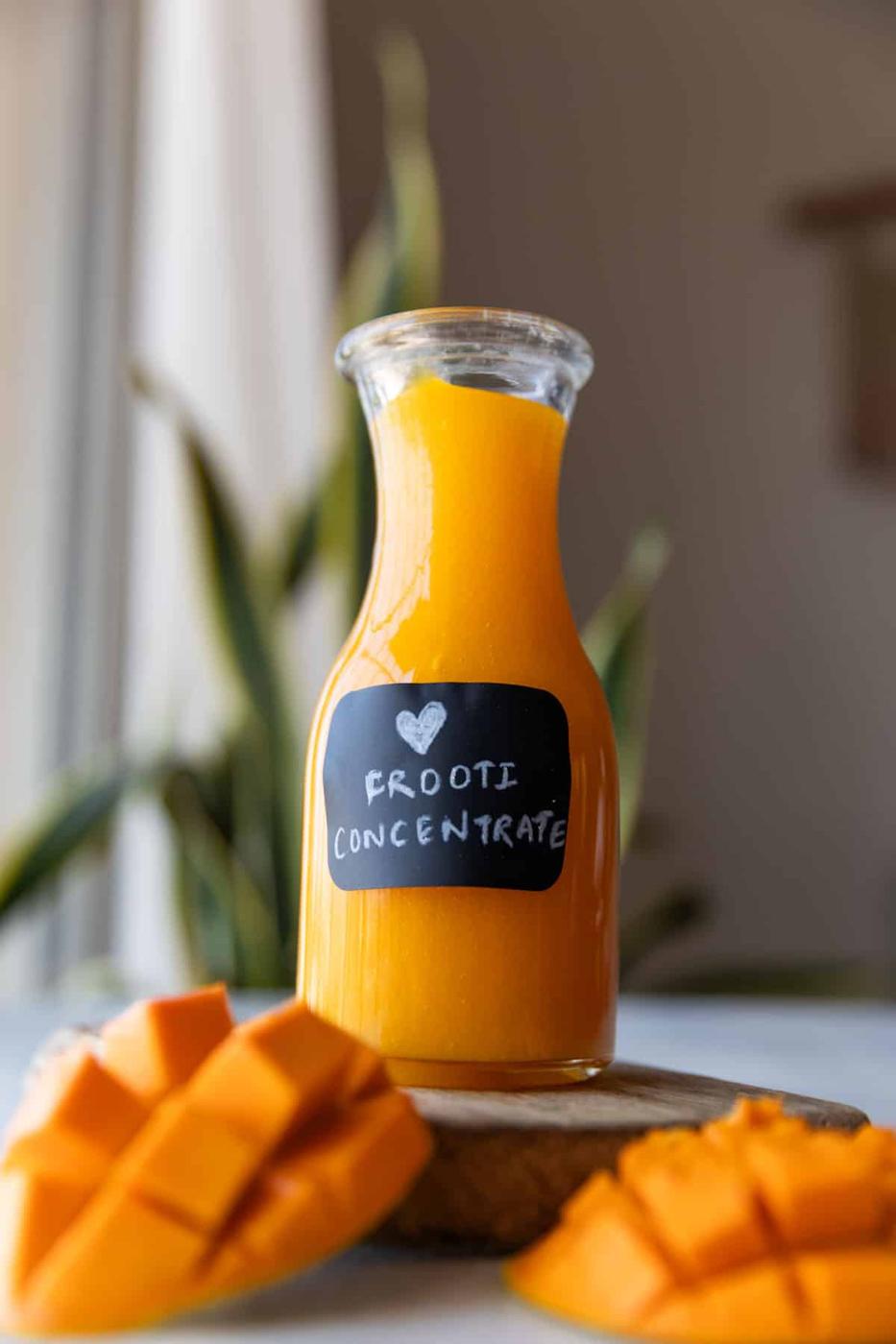 mango juice concentrate in a labeled glass bottle