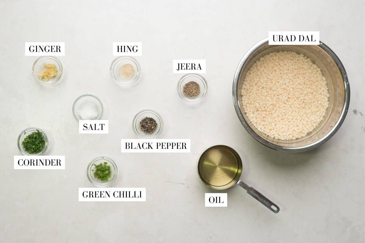 Picture of all the ingredients for medu vada with text overlay