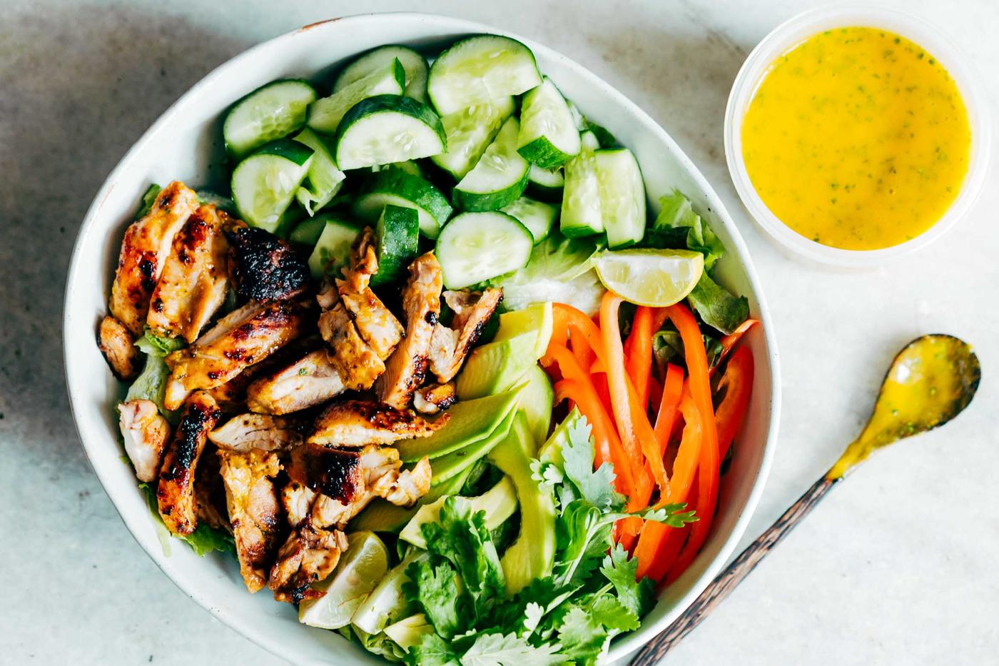 Grilled Chicken Mango Salad with Mango Cilantro Dressing is loaded with cucumbers, peppers, avocado and has a crazy good dressing that doubles up as a marinade! Best summer salad ever!