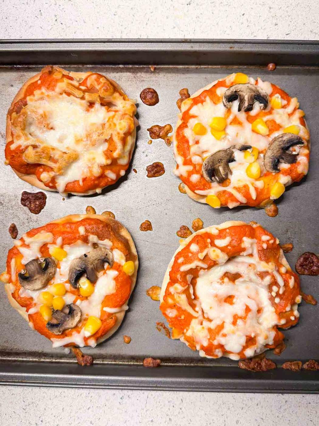 gour mini veg pizzas on an oven tray