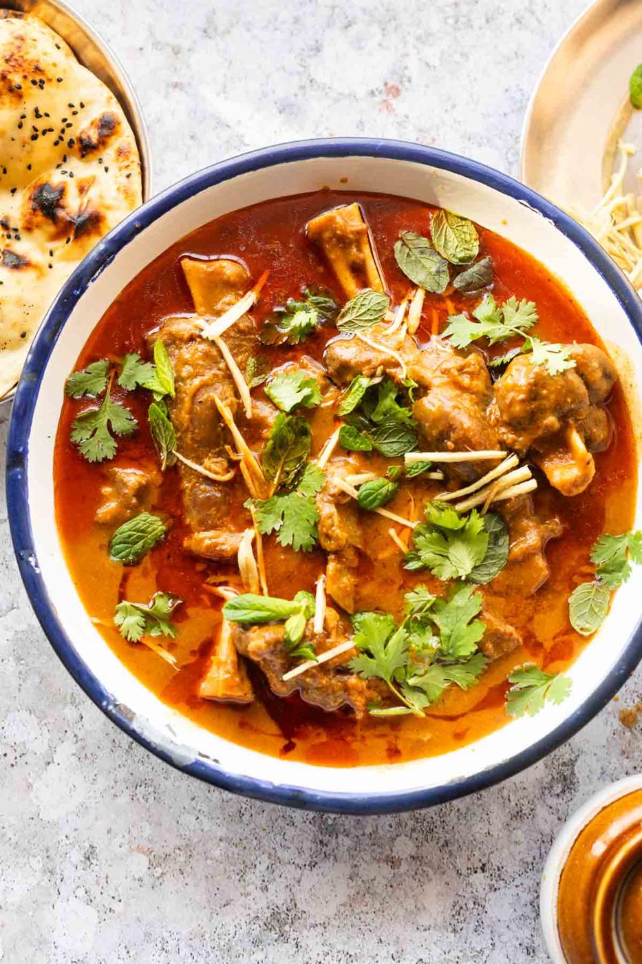 mutton nihari served on a bowl and garnished with coriander and julienned ginger
