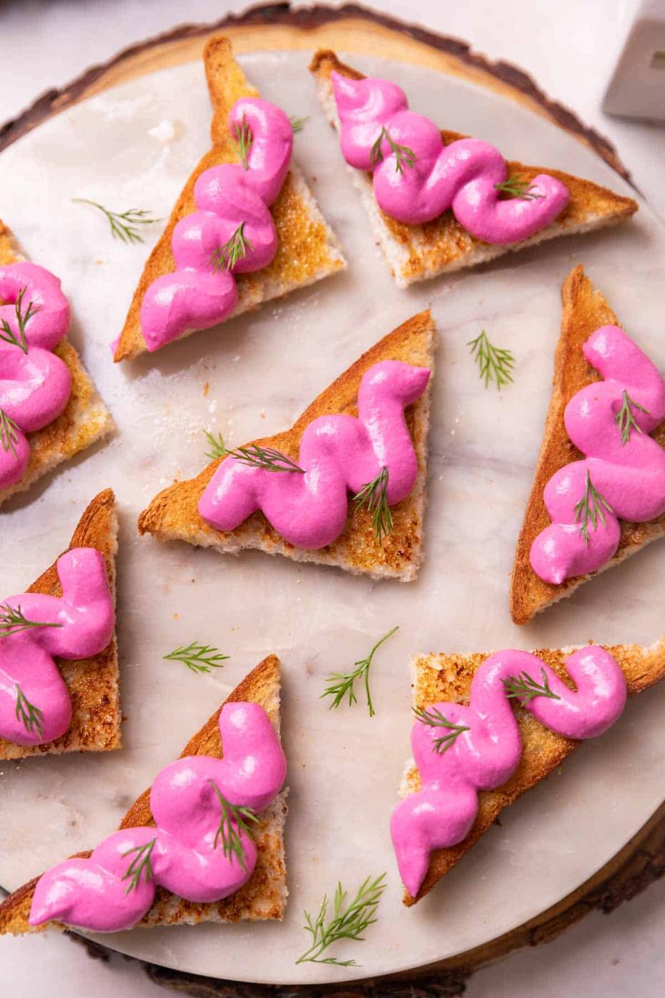 an image of several paneer toasts served on a round white platter