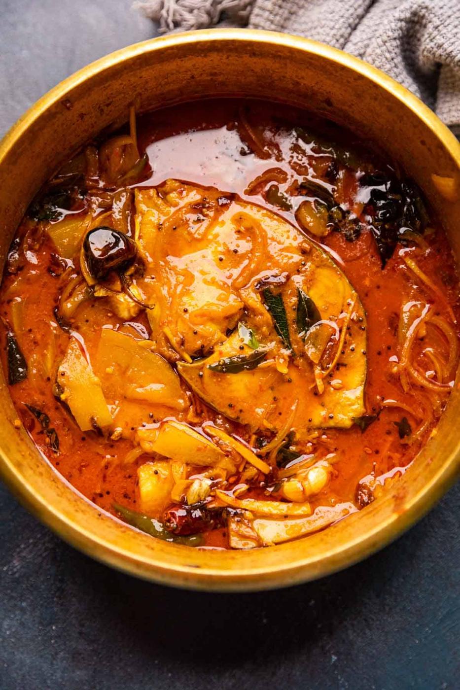 Raw Mango Fish Curry served in a brass pot that it was cooked in