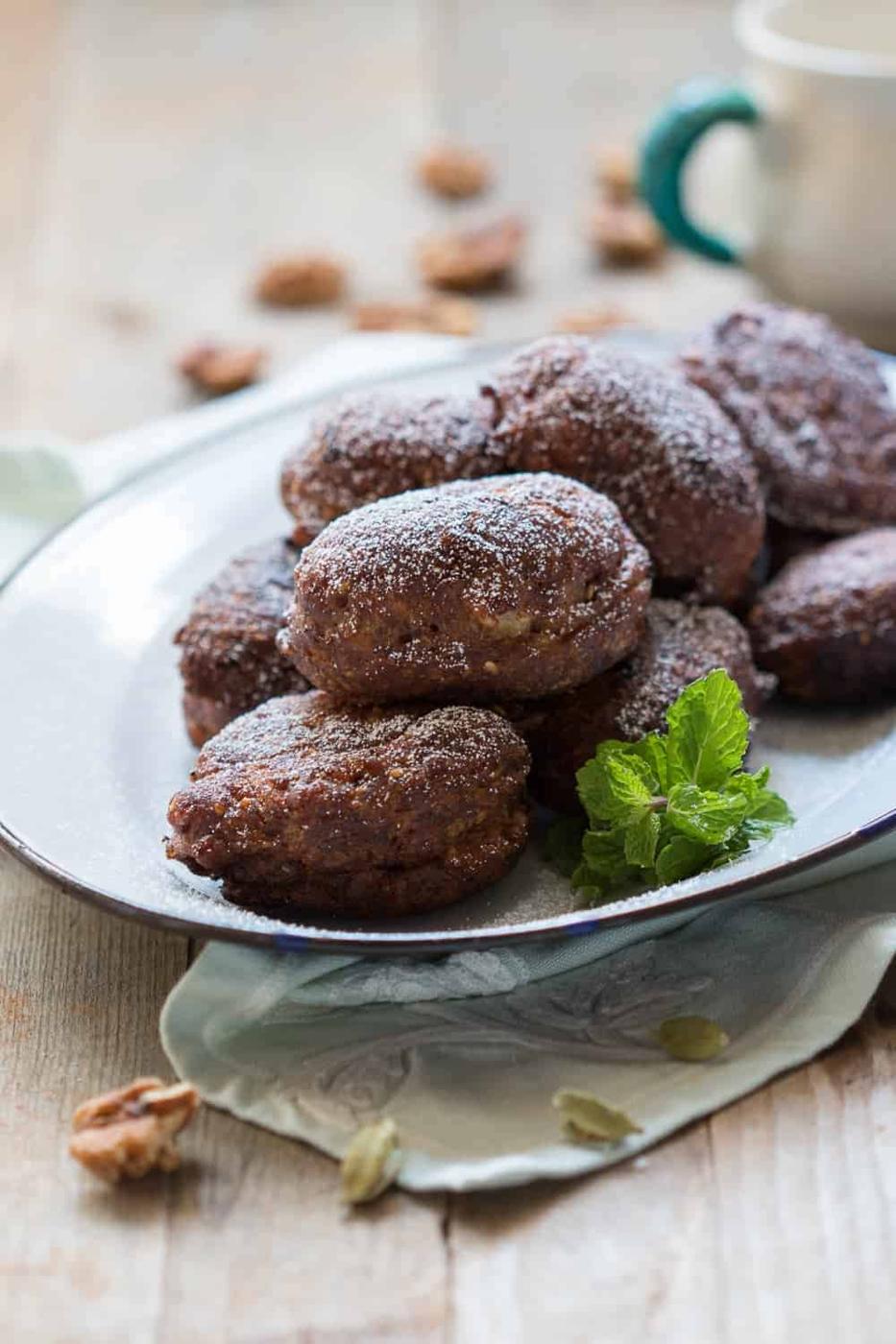 the fritters served in a white plate, garnished with mint leaves