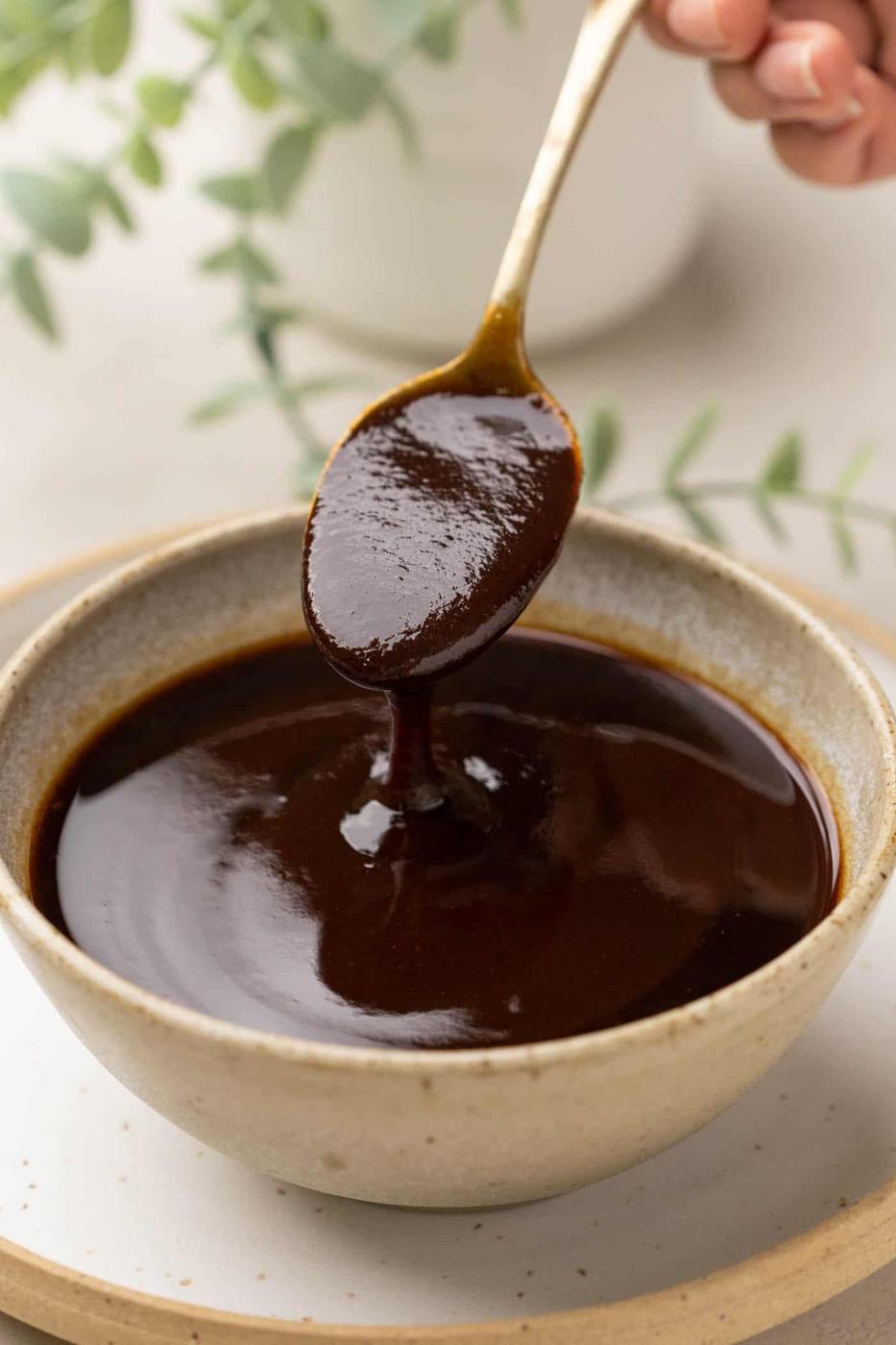 Tamarind Chutney being poured from a spoon into a bowl to show the texture