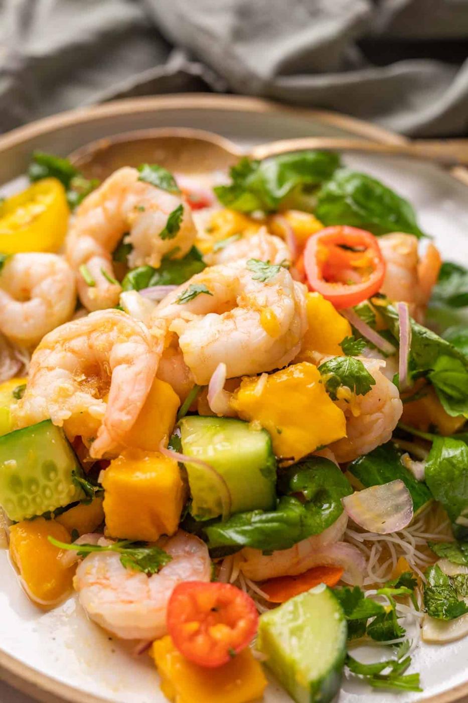 Clsoeup of prawn mango salad on a white plate