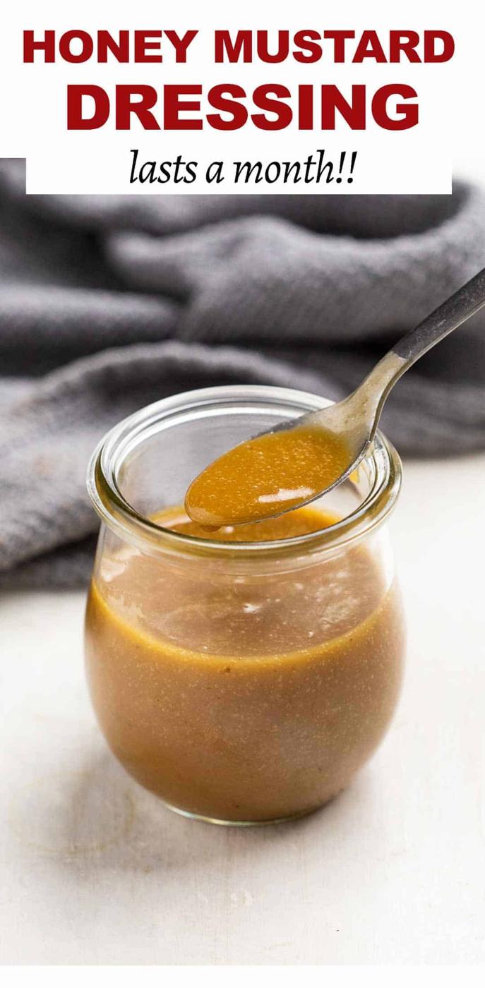 Honey mustard in a jar with a spoon being taken out