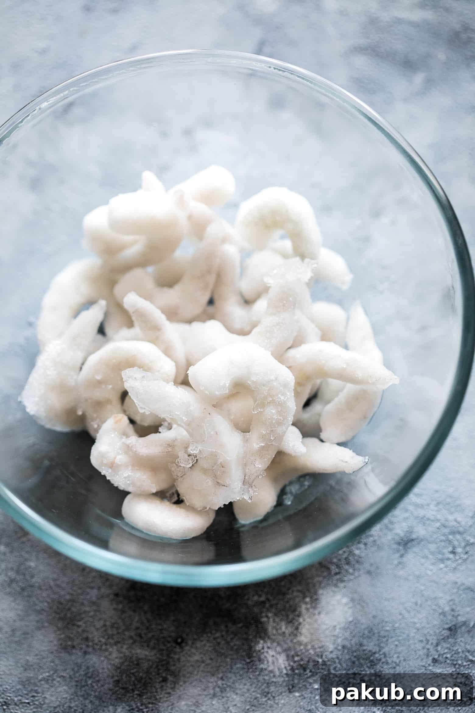 Keep Your Prawns Perfect: Safe Defrosting Methods 2 A vibrant image illustrating various safe defrosting methods for prawns and shrimp, with bowls of thawing seafood, cold water, and a refrigerator in the background. Emphasizes expert techniques for all types of seafood.
