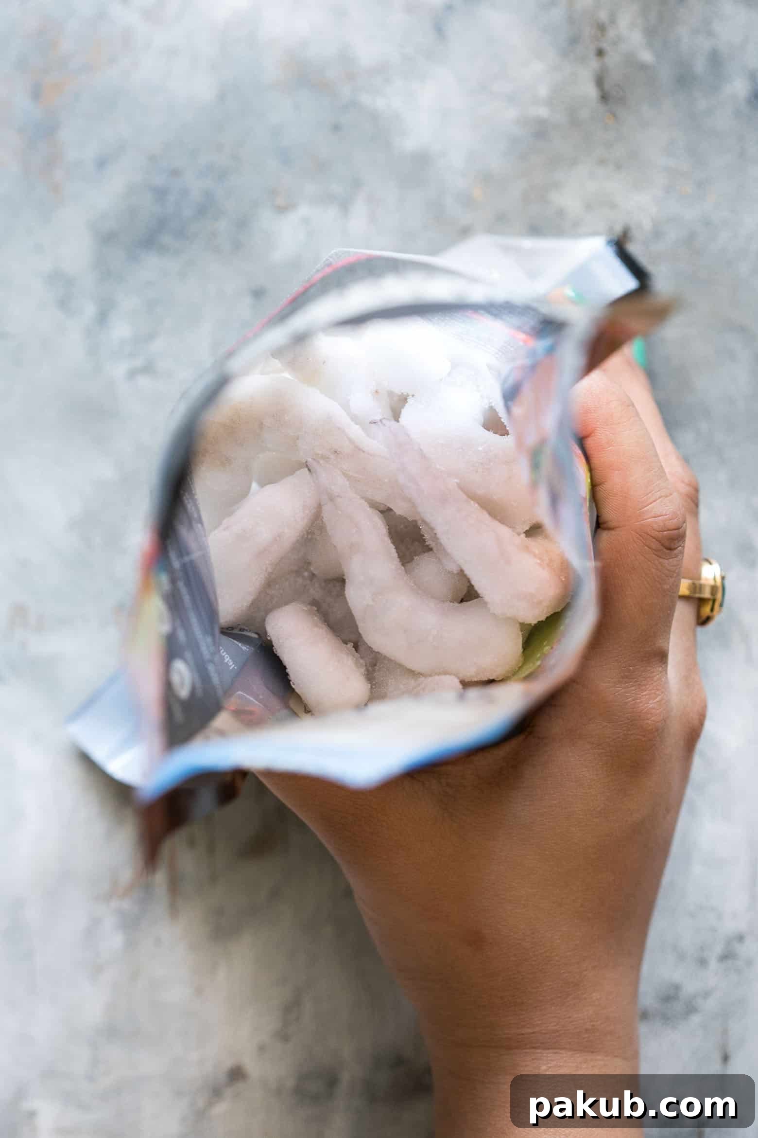 Keep Your Prawns Perfect: Safe Defrosting Methods 5 The refrigerator thawing method is the safest way to defrost prawns and other seafood, allowing for a slow, even thaw that preserves texture and flavor. This image shows prawns gently thawing in a container inside a refrigerator.