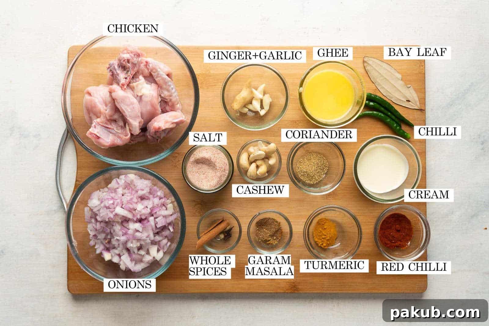 Carefully arranged ingredients for Mughlai Chicken, highlighting fresh spices, chicken, and aromatics.