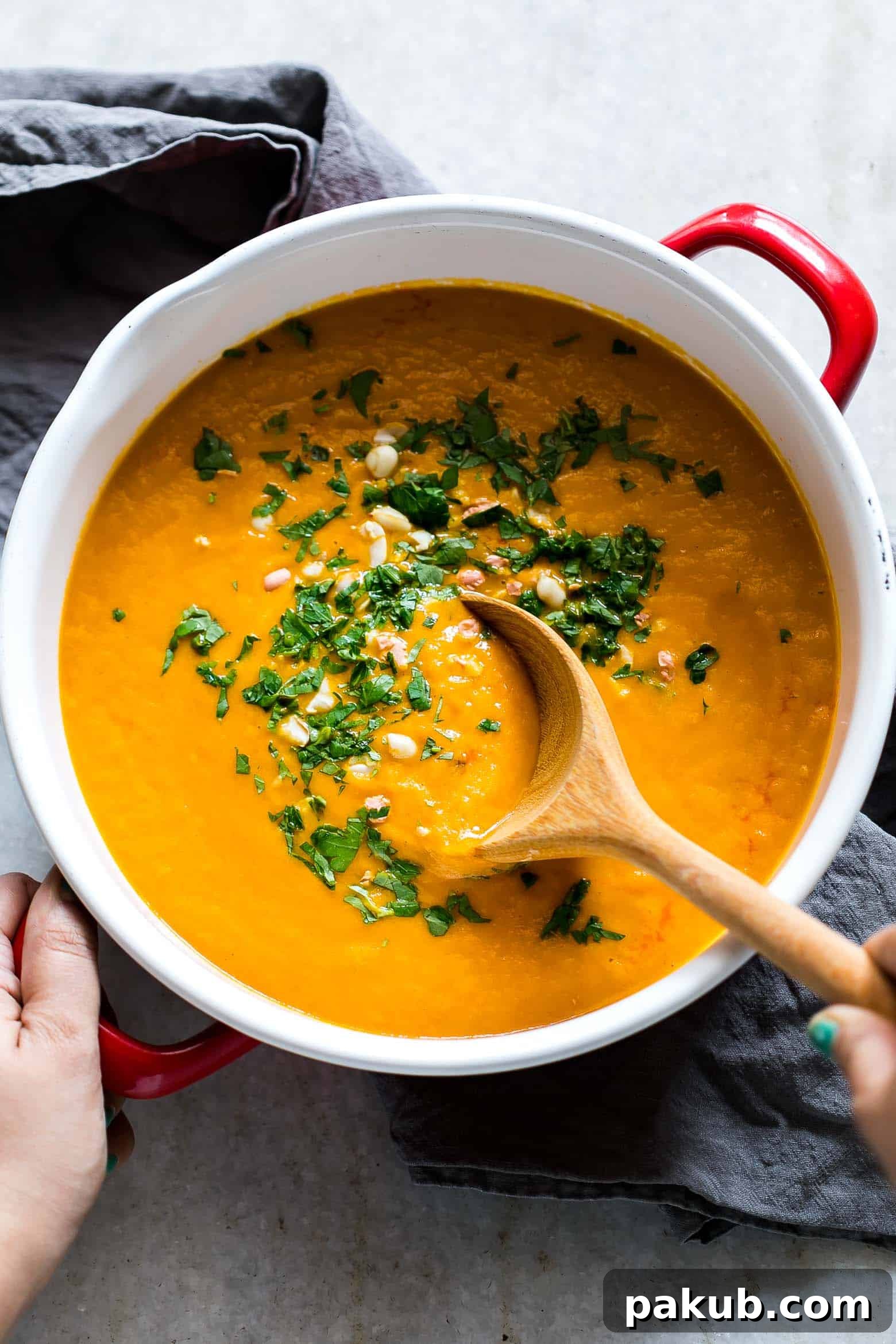 Thai Ginger Carrot Soup garnished with fresh cilantro and a swirl of coconut milk, ready to be served.