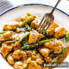 Zesty Lemon Ginger Chicken Asparagus Stir Fry 5 Lemon Ginger Chicken Asparagus Stir Fry served on a white plate.