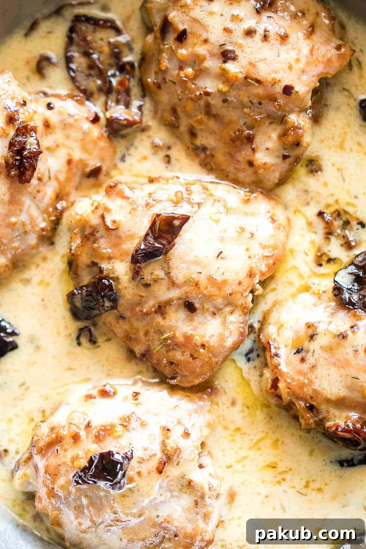 Creamy Tuscan Chicken and Sun-dried Tomato Pasta 3 Creamy Sun-dried Tomato Chicken being stirred in a pan.