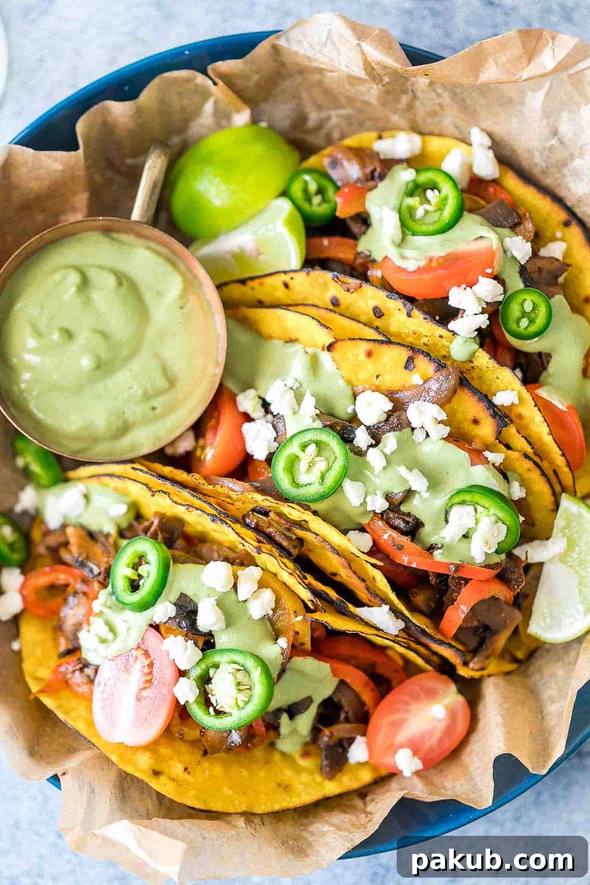 Vegetarian Portobello Mushroom Fajita Tacos served with avocado cilantro sauce on the side.