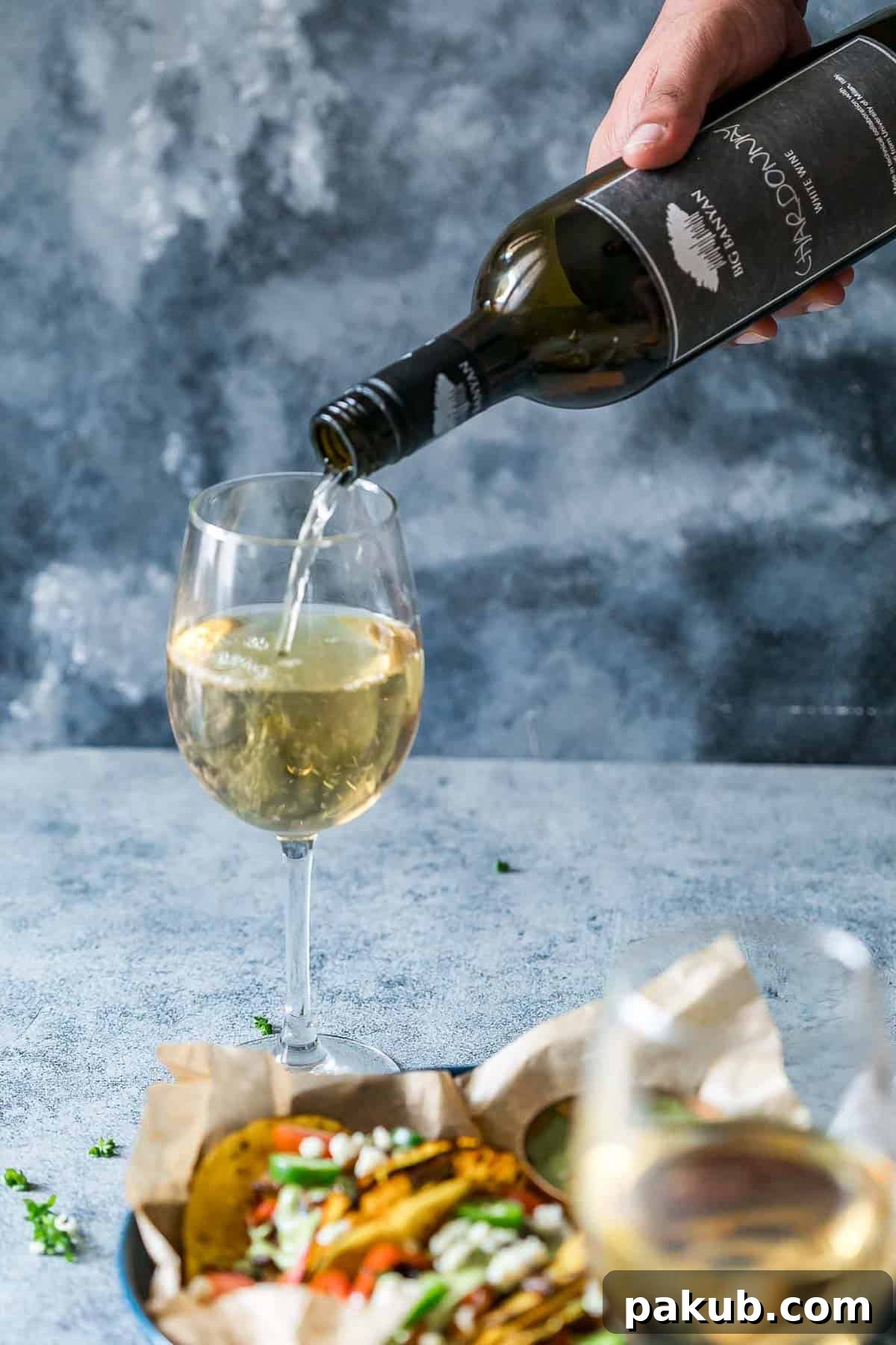 Vegetarian Portobello Mushroom Fajita Tacos paired with a glass of Big Banyan's Chardonnay white wine.