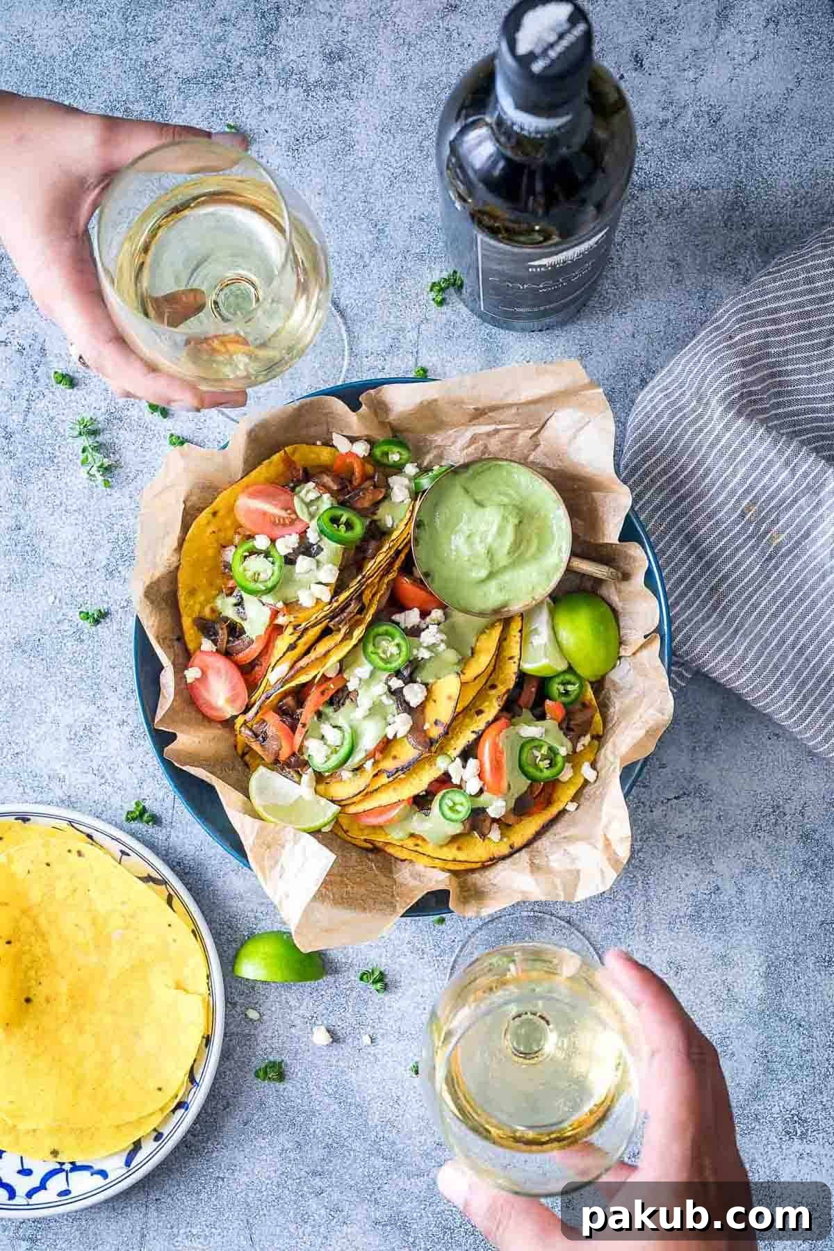Vegetarian Portobello Mushroom Fajita Tacos served with avocado cilantro sauce on the side and being enjoyed with Big Banyan's Chardonnay white wine.