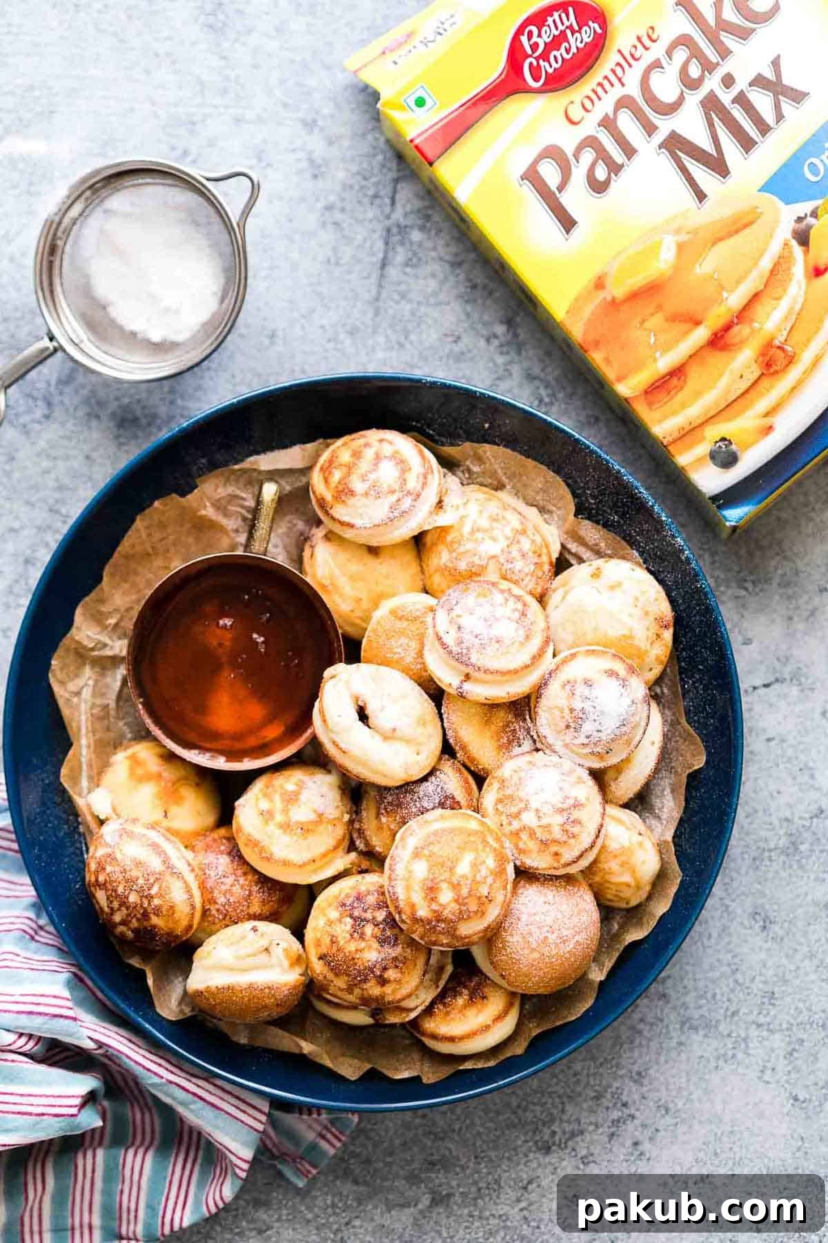 Chocolate Stuffed Mini Pancake Bites served with maple syrup on the side.