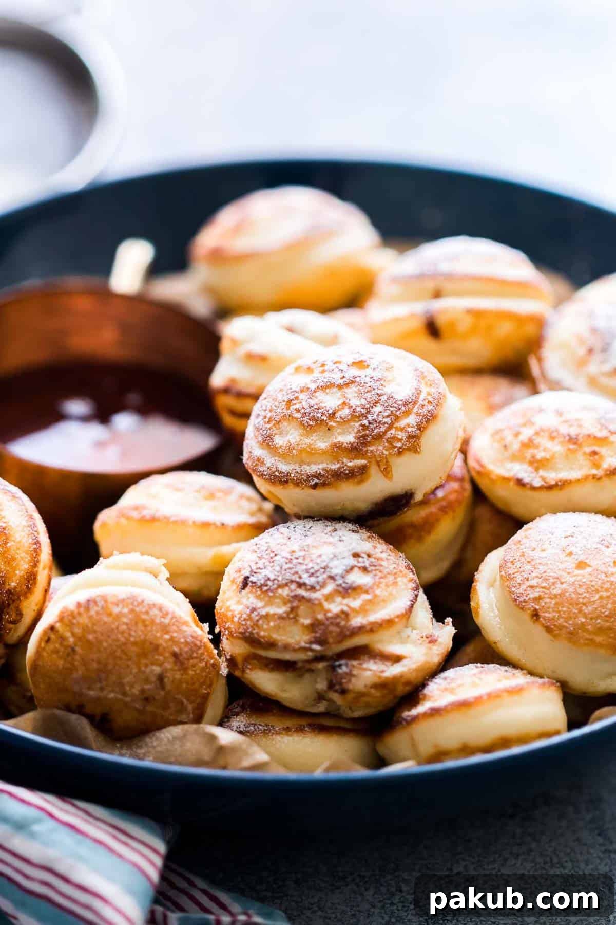 Chocolate Stuffed Mini Pancake Bites served with maple syrup on the side.