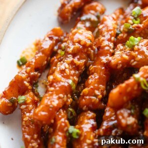 Close up image of crispy honey chilli potatoes, showcasing their appealing texture